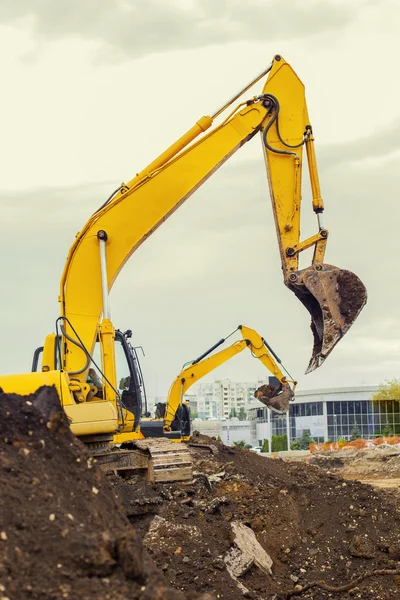 Two excavators are digging earth on the construction site. — Stock Photo, Image