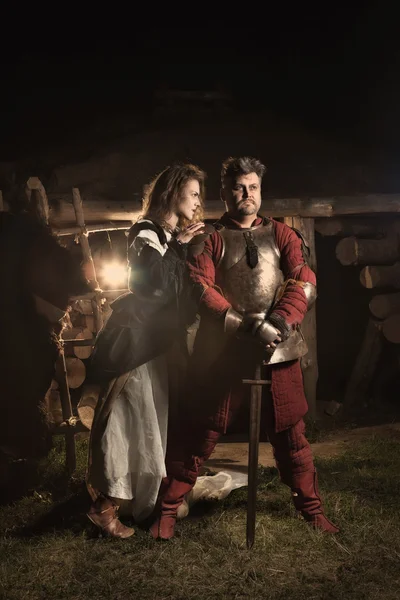 Medieval peasant woman is flirting with the knight — Stock Photo, Image