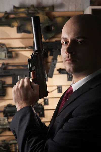 Bald hitman with the gun — Stock Photo, Image