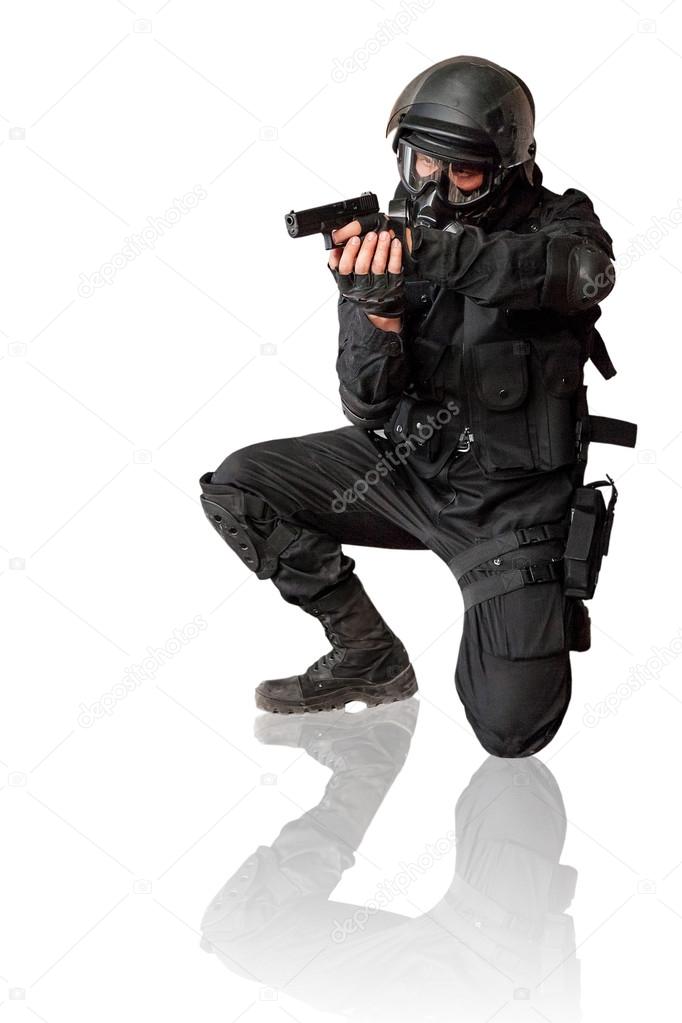 Armed man in protactive cask with a pistol. Isolated on white.