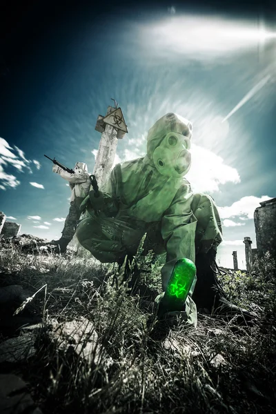 Two soldiers in the gas masks and protective clothes are testing Stock Picture