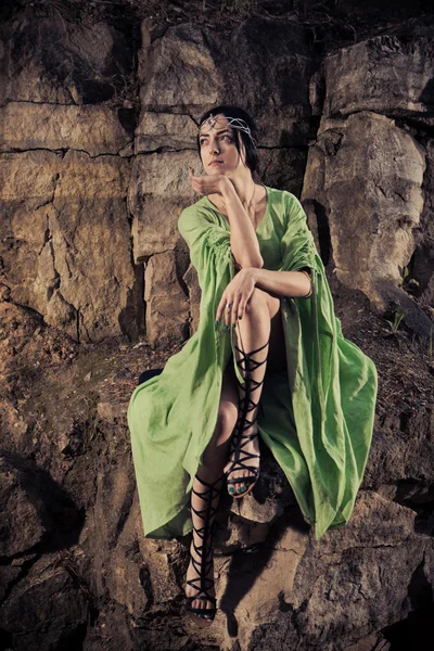 Elf woman is sitting on the rock. — Stock Photo, Image