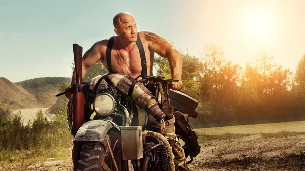 Muscular bald biker on the autumn background — Stock Photo, Image