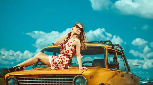 Mulher bonita está deitado no carro velho — Fotografia de Stock