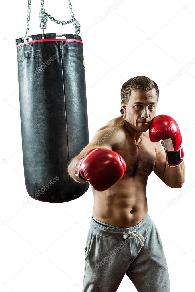 Muscular boxer near the boxing bag. Isolated on white background