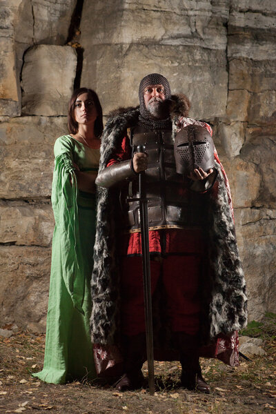 Old King with the sword is leaving his princess. Rocks on the ba