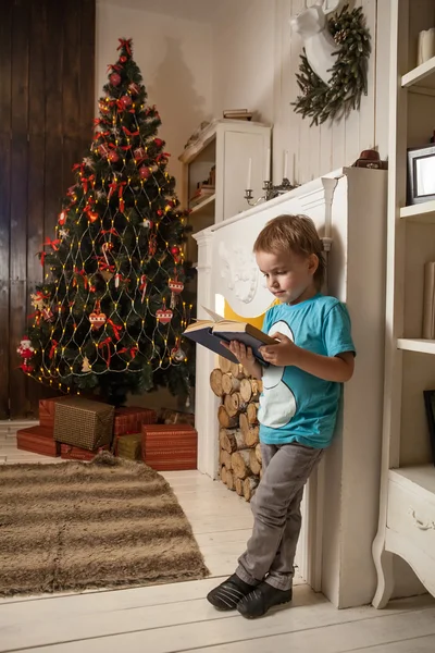 Симпатичный блондин читает книгу сказок на Рождество — стоковое фото
