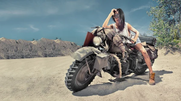 Sexy biker woman on the desert background. — Stock Photo, Image