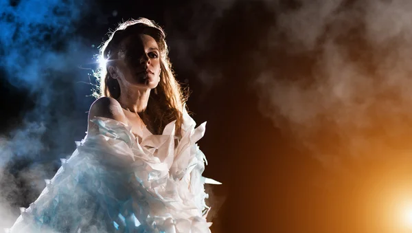 Portrait of a white angel on the color fog background — Stock Photo, Image