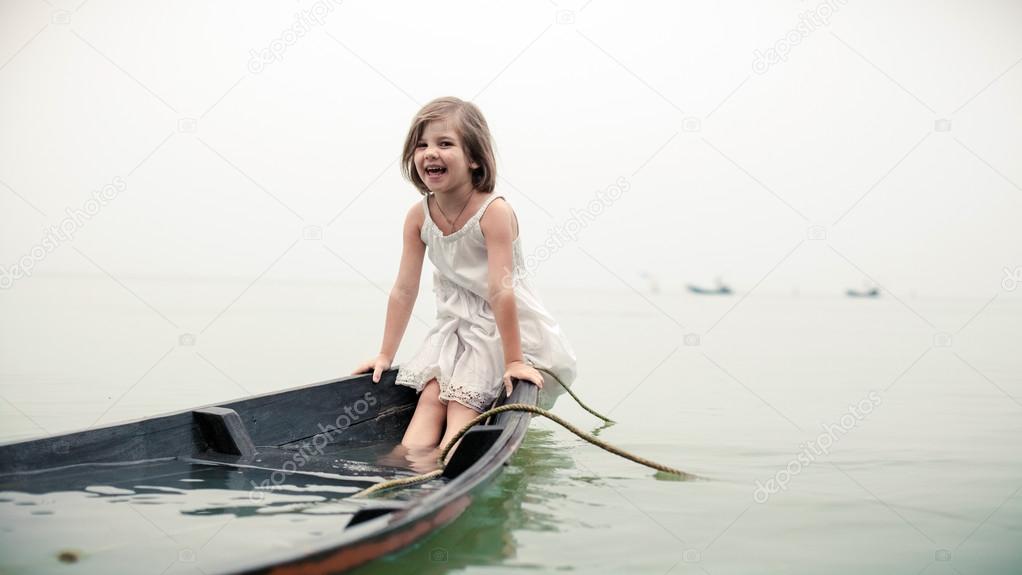 Beautiful young girl in the sinking boat. 