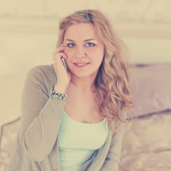 Blonde lying and talking on phone — Stock Photo, Image