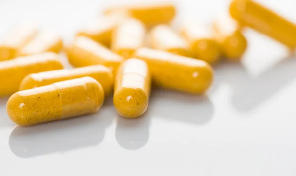 Heap of yellow pills — Stock Photo, Image