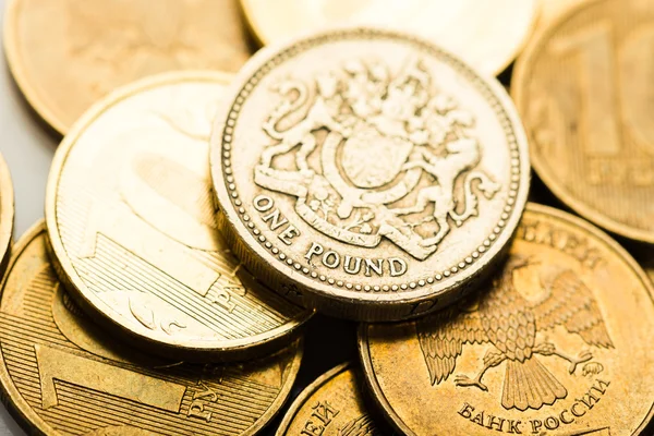 Pound coin on ruble coins — Stock Photo, Image