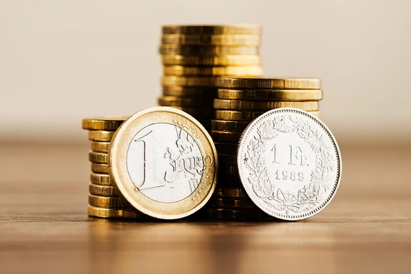 One euro coin and one swiss frank — Stock Photo, Image