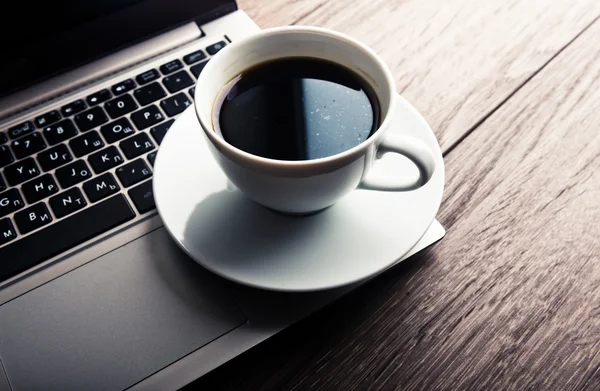 Kopje koffie en laptop — Stockfoto