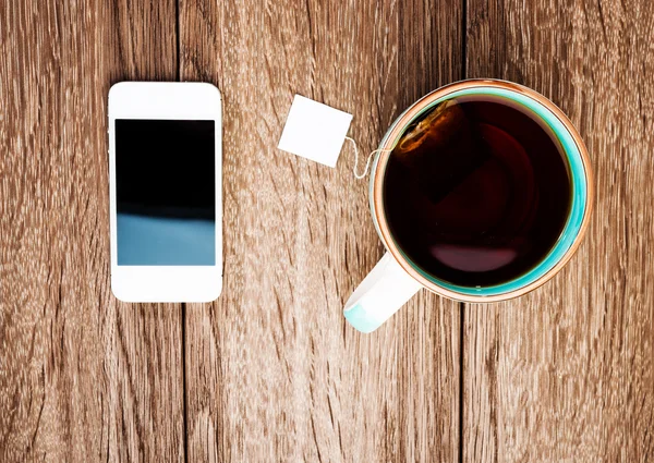 Cup of tea and phone — Stock Photo, Image