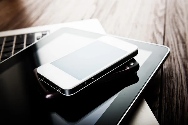 Phones and tablet pc on desk — Stock Photo, Image