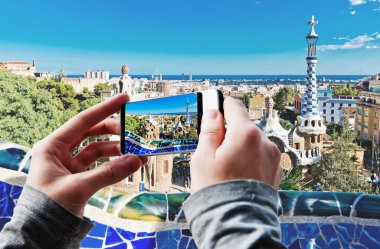 Tourist taking a picture in Barcelona, Spain. clipart