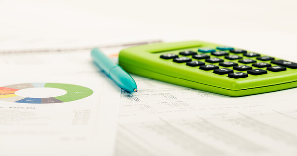 Financial papers, calculator and pen