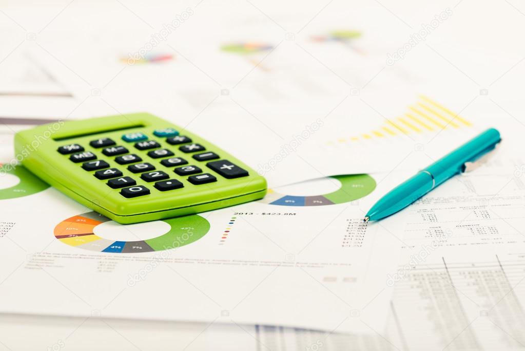 Financial papers, calculator and pen