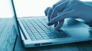 Women's hands typing on computer