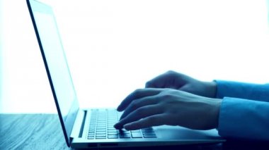 Women's hands typing on computer