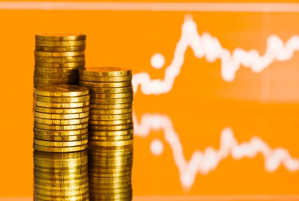 Gold money and fluctuating graph — Stock Photo, Image