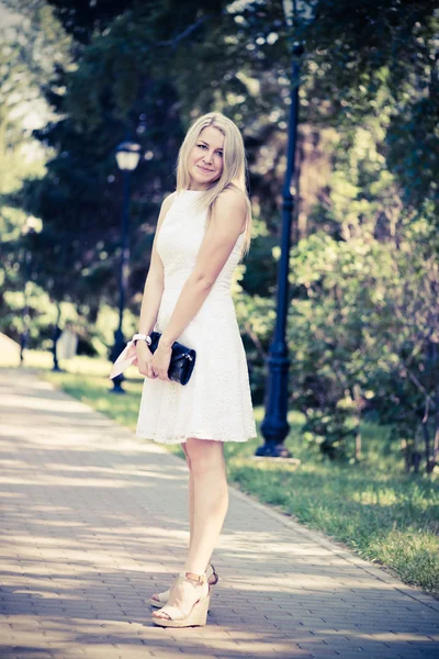 Blond woman in a white dress outdoors — Stock Photo, Image