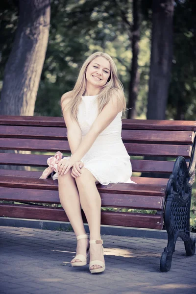 Mulher sentada no banco no parque — Fotografia de Stock