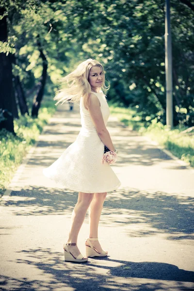 Blond woman in a white dress outdoors — Stock Photo, Image