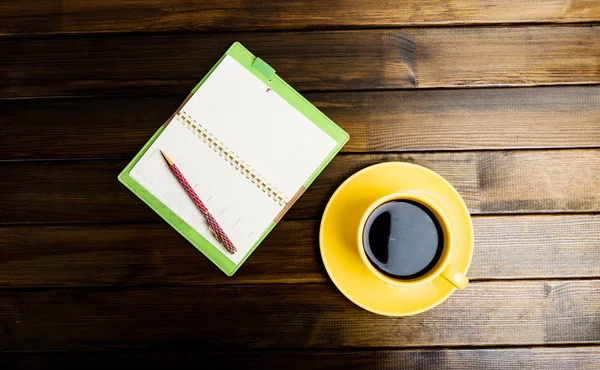 Notebook and cup of coffee — Stock Photo, Image