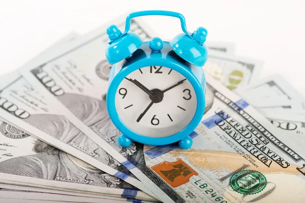 Alarm clock and dollars banknotes — Stock Photo, Image