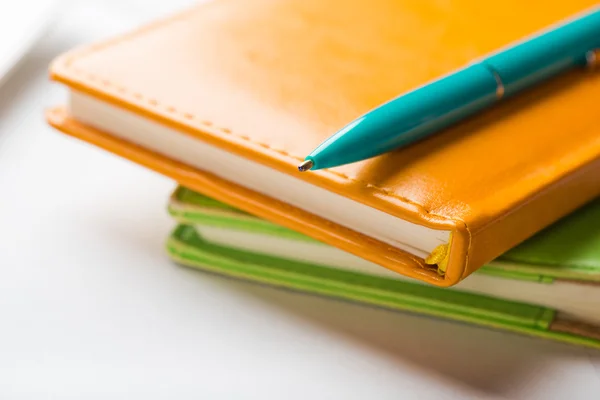 Colorful notebooks and pen — Stock Photo, Image