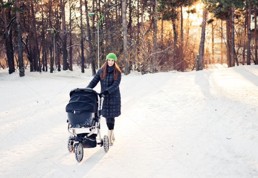 Woman with stroller going for walk