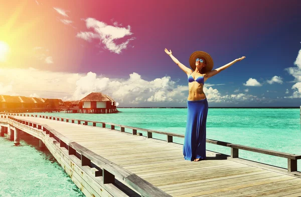 Woman on a beach jetty — Stock Photo, Image