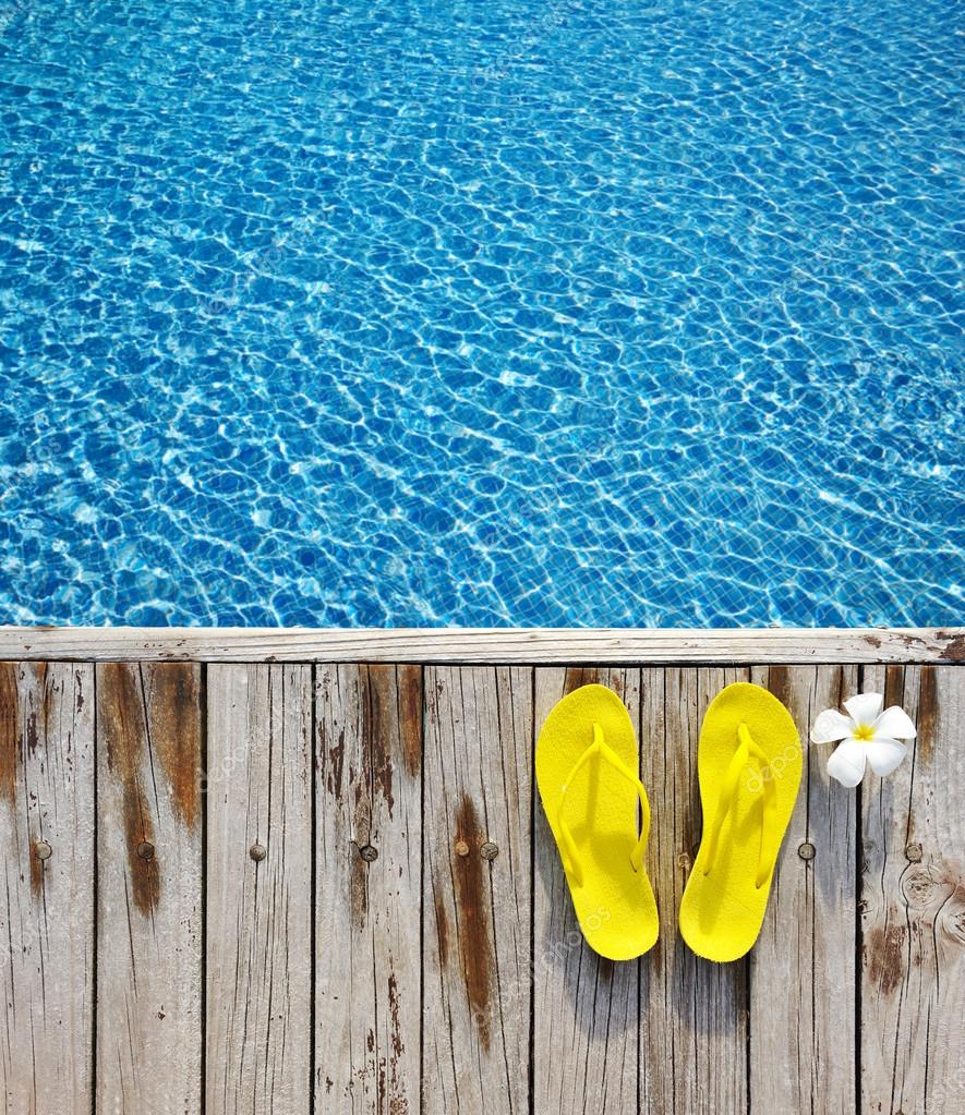 Flip-flops by swimming pool Stock Photo by ©haveseen 105630946