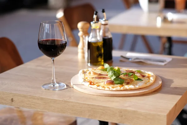 Pizza och ett glas rött vin — Stockfoto