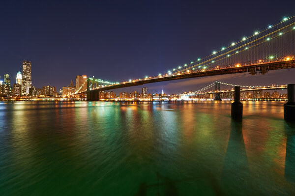 NEW YORK CITY, USA - APRIL 2: Brooklyn Bridge with lower Manhattan skyline in New York City at night