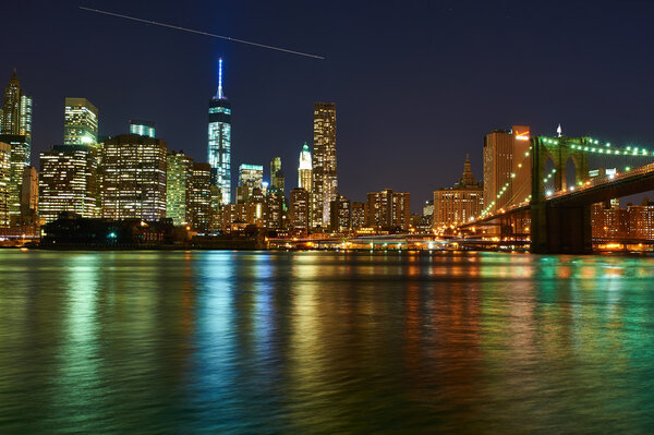 NEW YORK CITY, USA - APRIL 2: Brooklyn Bridge with lower Manhattan skyline in New York City at night