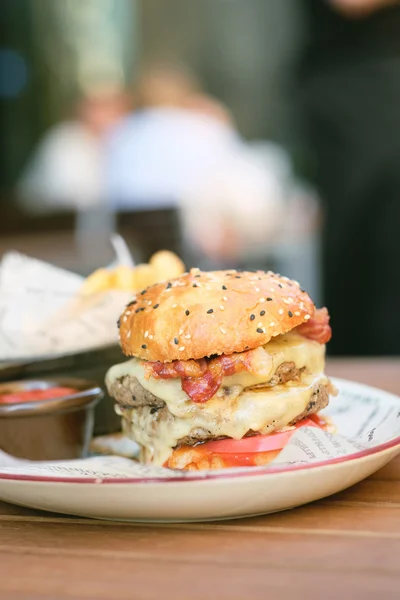 Double cheeseburger on table