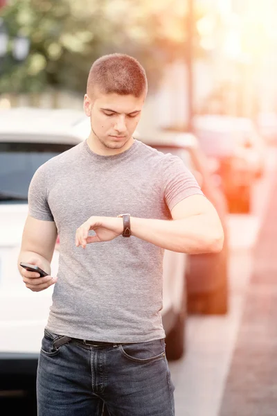Man looking on wrist watch — Stock Photo, Image
