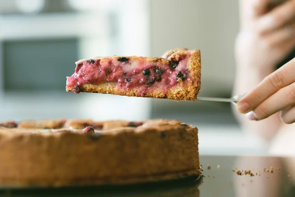 Woman holding pie slice