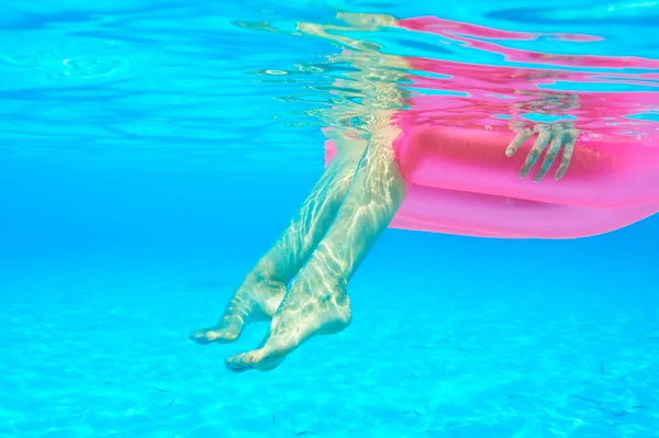 Woman relaxing on inflatable mattress — Stock Photo, Image