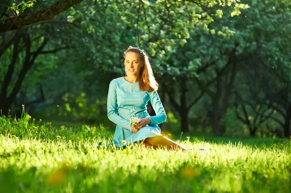 Frau im Kleid zwischen Apfelblüten — Stockfoto