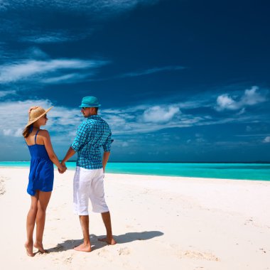 Couple on beach at Maldives clipart