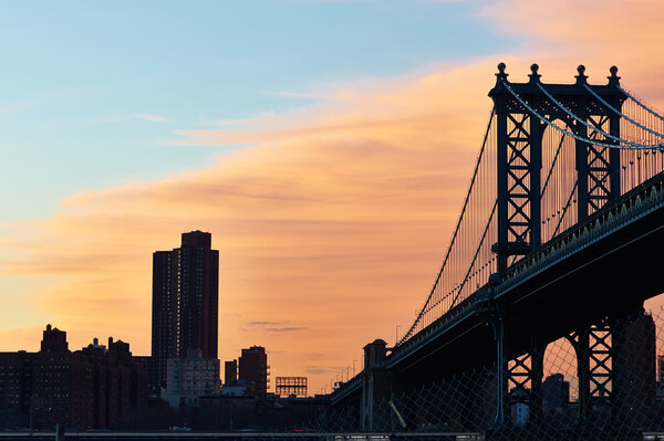 Manhattan Bridge and skyline silhouette view from Brooklyn in New York City at sunset