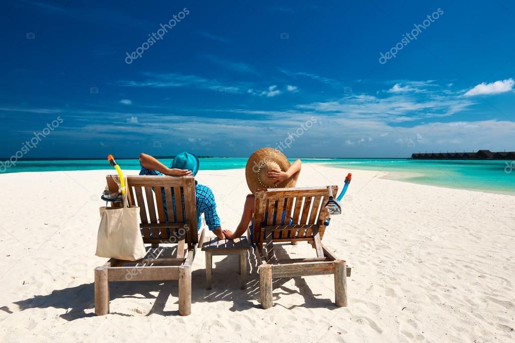 Couple relax on beach