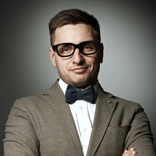 Confident nerd in eyeglasses and bow tie — Stock Photo, Image