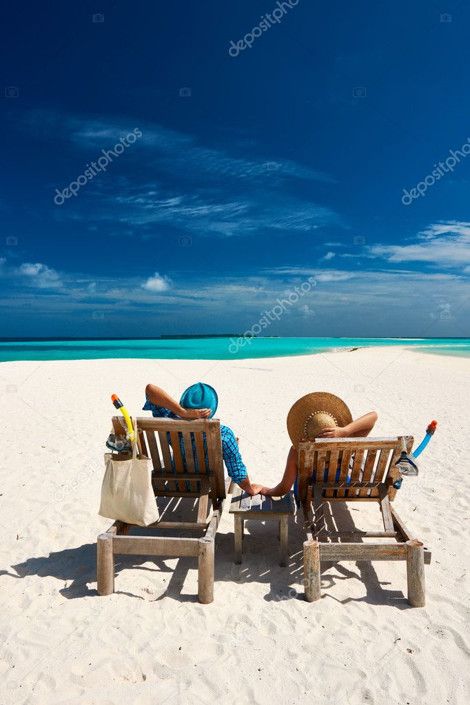 Couple relax on a beach at Maldives