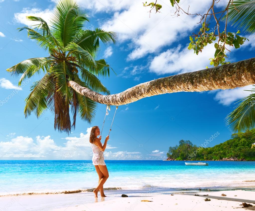 Woman swinging at beach